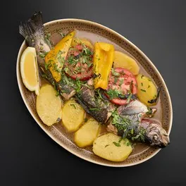 Ishkhan baked whole with potatoes and peppers