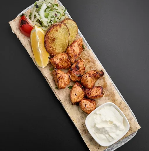 Shish taouk on lavash with grilled potato, lemon and garlic sauce
